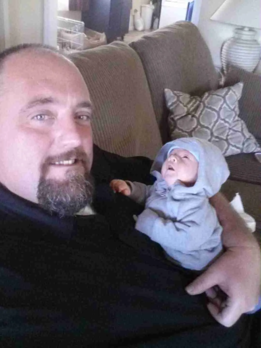 Brian Spiker, owner of Spiker Carpet & Tile Care, holding his son